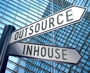 Crossroads sign with two arrows, office building - inhouse, outsource